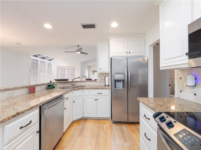 kitchen with a ceiling fan, visible vents, a sink, decorative backsplash, and appliances with stainless steel finishes