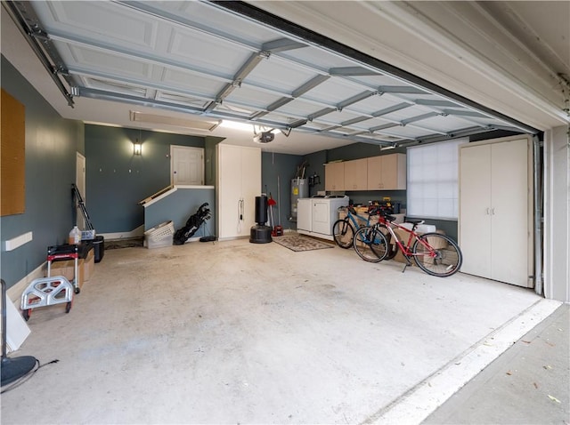 garage with washer / dryer, gas water heater, and a garage door opener