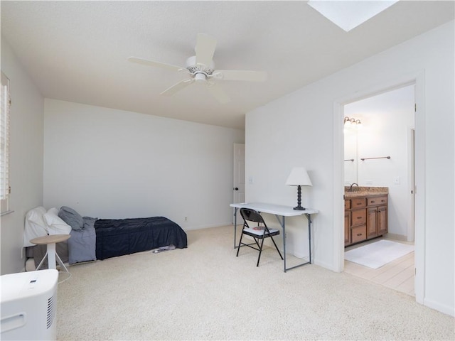 bedroom featuring ceiling fan, ensuite bath, baseboards, and light carpet