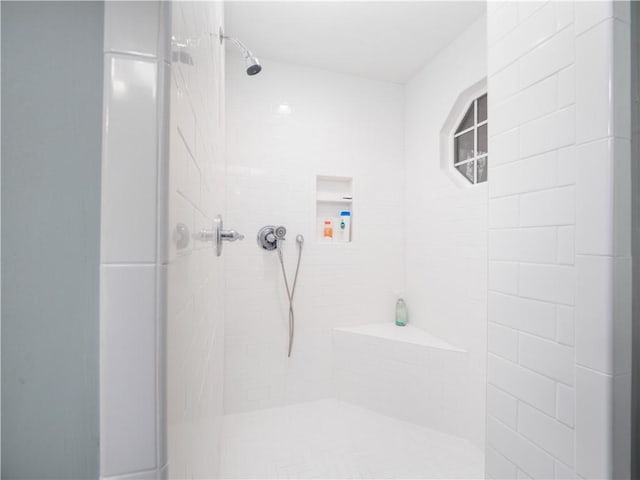 full bath featuring a tile shower