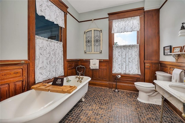 1000 Union St, Brunswick, GA 31520 - bathroom featuring wainscoting, a soaking tub, vanity, and wooden walls
