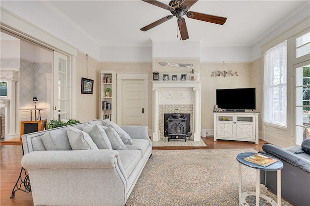 1000 Union St, Brunswick, GA 31520 - living area with a wood stove, wood finished floors, plenty of natural light, ceiling fan, and ornamental molding