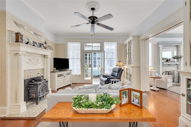 1000 Union St, Brunswick, GA 31520 - living area with wood finished floors, ceiling fan, a wood stove, and ornamental molding