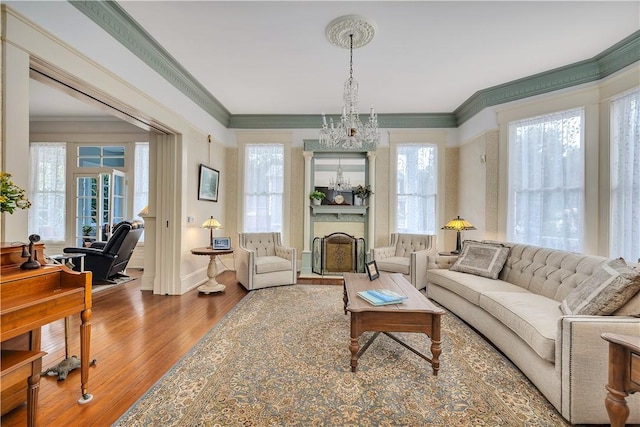 1000 Union St, Brunswick, GA 31520 - living room with crown molding, wood finished floors, a chandelier, and a large fireplace