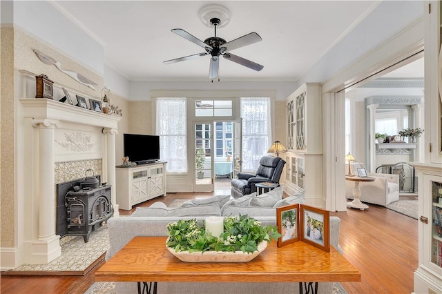 1000 Union St, Brunswick, GA 31520 - living room with wood finished floors, a ceiling fan, a wood stove, and crown molding