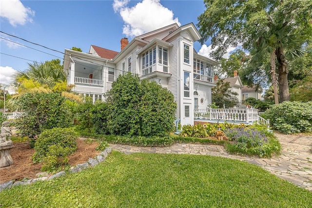 1000 Union St, Brunswick, GA 31520 - view of front of property with a front yard, a chimney, and a balcony