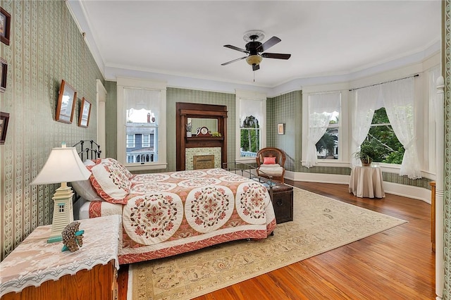1000 Union St, Brunswick, GA 31520 - bedroom with wallpapered walls, multiple windows, crown molding, wood finished floors, and a fireplace