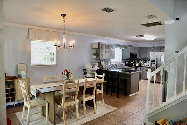 102 Avalon Ct, Kingsland, GA 31548 - dining area featuring a chandelier, ornamental molding, and stairway