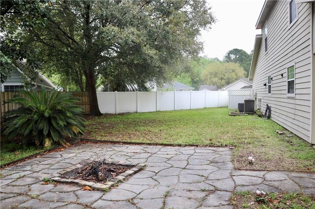 102 Avalon Ct, Kingsland, GA 31548 - fenced backyard with a patio and an outdoor fire pit