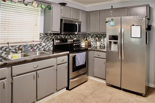102 Avalon Ct, Kingsland, GA 31548 - kitchen featuring appliances with stainless steel finishes, gray cabinets, dark countertops, and backsplash