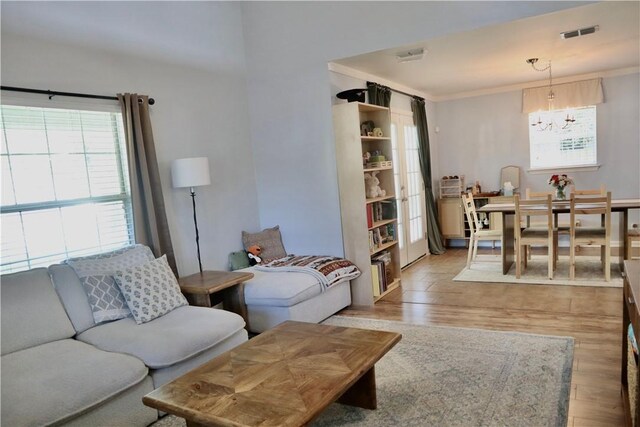 102 Avalon Ct, Kingsland, GA 31548 - living room with a chandelier, light wood finished floors, and crown molding