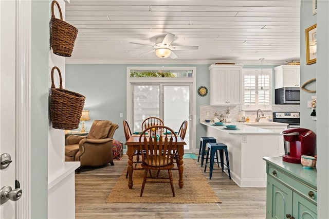 1035 Beachview Dr Unit 201, Saint Simons Island, GA 31522 - dining space with wooden ceiling, light wood finished floors, ceiling fan, and crown molding