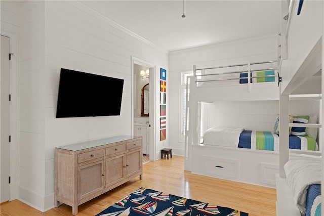 bedroom featuring light wood-type flooring and ornamental molding
