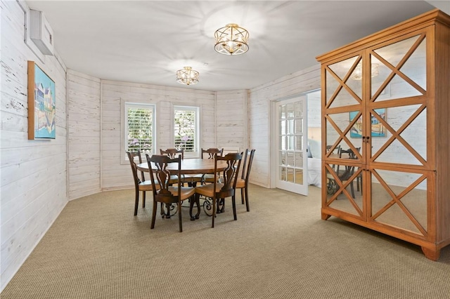 carpeted dining space with a chandelier