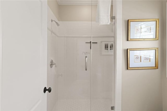 full bath with a shower stall and crown molding