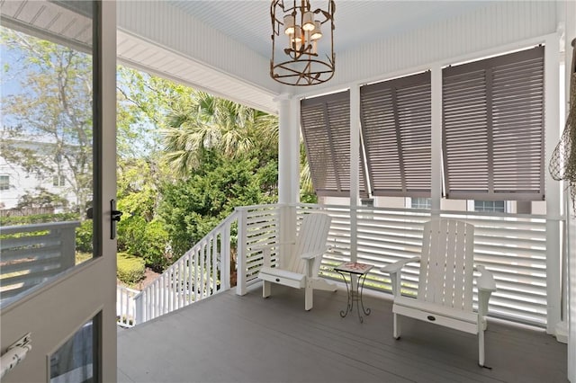 exterior space with an inviting chandelier