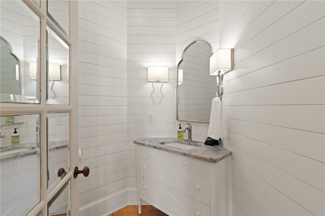 bathroom featuring two vanities and a sink