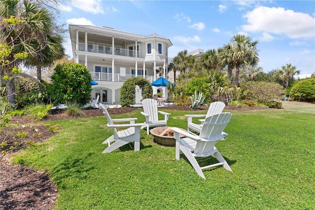 exterior space featuring a lawn and an outdoor fire pit