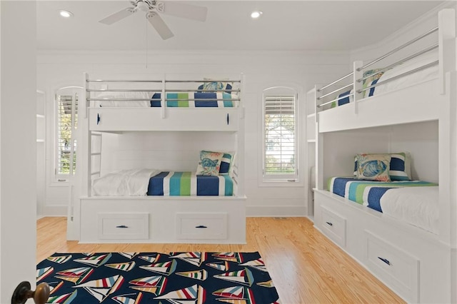 bedroom featuring recessed lighting, crown molding, and light wood finished floors