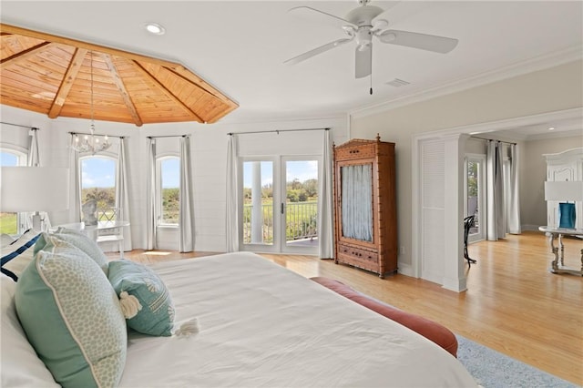 bedroom with crown molding, wood finished floors, access to exterior, and multiple windows