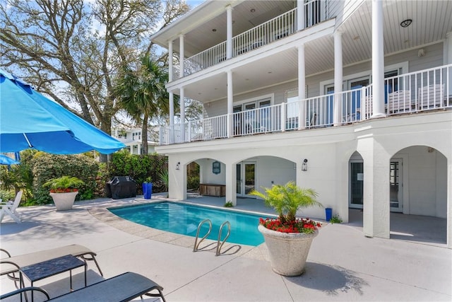 pool featuring a grill and a patio