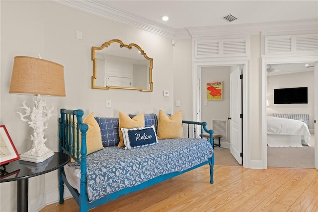 bedroom featuring ornamental molding, wood finished floors, visible vents, and recessed lighting