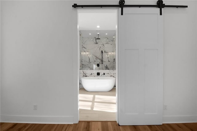 bathroom featuring separate shower and tub and hardwood / wood-style flooring