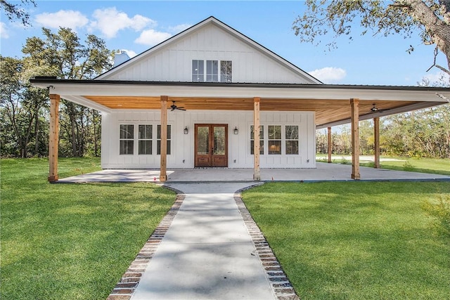 view of front facade with ceiling fan, a front lawn, french doors, and a patio