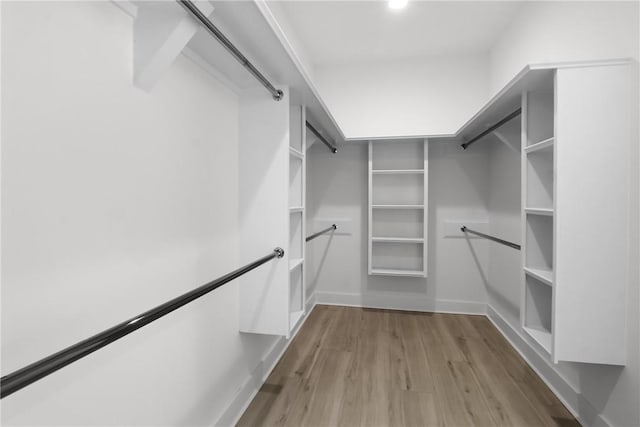 walk in closet with wood-type flooring