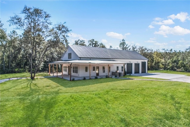 view of front of house with a garage, a front yard, and a porch