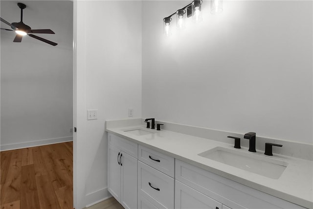 bathroom with ceiling fan, hardwood / wood-style flooring, and vanity