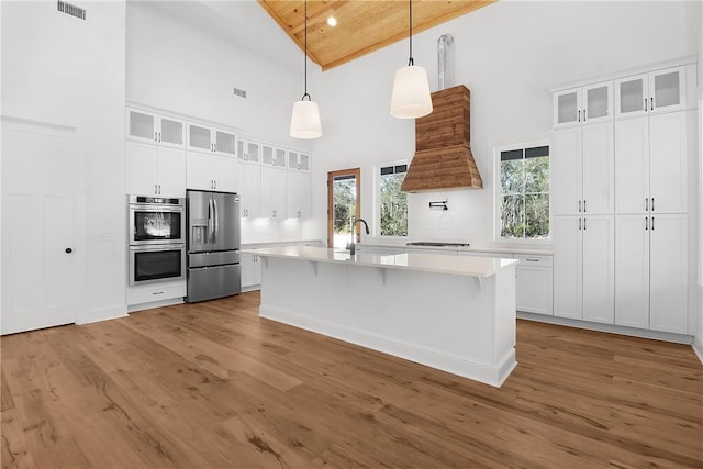 kitchen featuring white cabinets, pendant lighting, appliances with stainless steel finishes, and wood ceiling