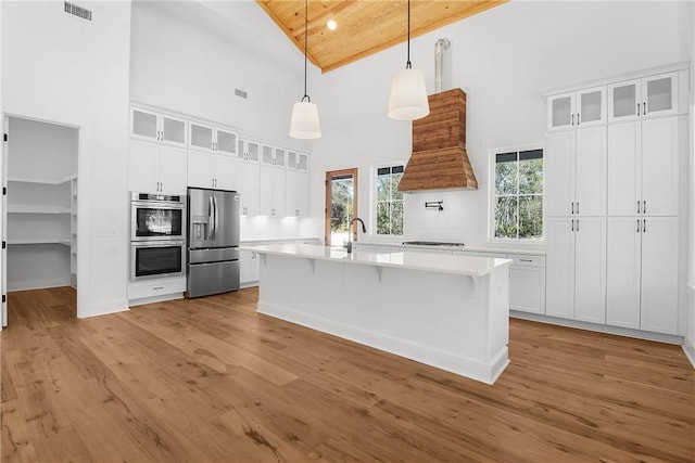 kitchen featuring white cabinetry, wooden ceiling, appliances with stainless steel finishes, decorative light fixtures, and high vaulted ceiling