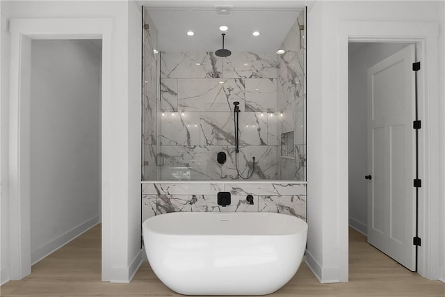 bathroom with independent shower and bath and hardwood / wood-style flooring