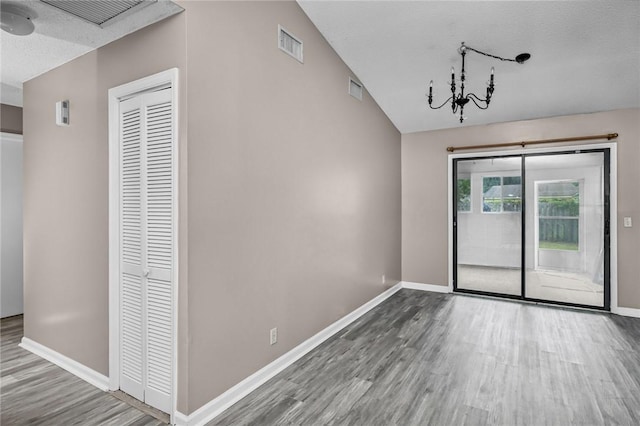 311 Sunnyside Dr, Saint Marys, GA 31558 - unfurnished room featuring wood finished floors, baseboards, lofted ceiling, and a textured ceiling