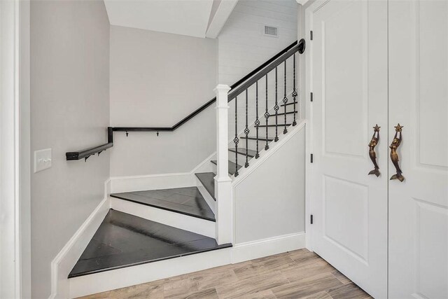 staircase featuring hardwood / wood-style flooring