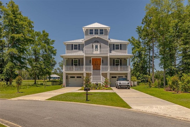 view of front of house with a porch, a garage, and a front yard