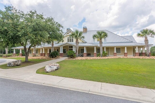 view of front of property with a front yard and covered porch