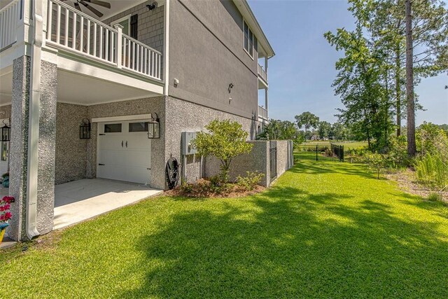 view of property exterior with a yard, ceiling fan, a balcony, and a garage