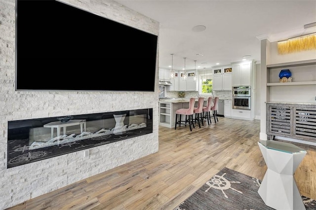 living room with a fireplace and light hardwood / wood-style floors