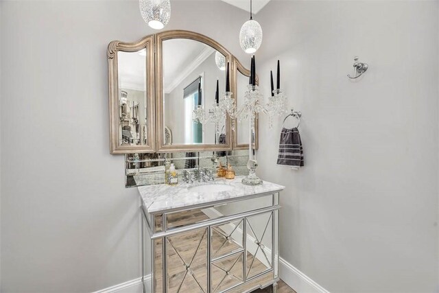 bathroom featuring vanity, tasteful backsplash, and ornamental molding