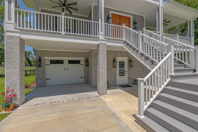 exterior space with a porch, a garage, and ceiling fan