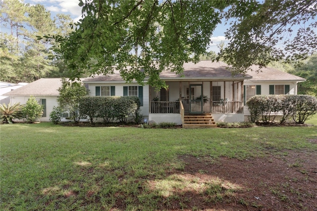 back of house with a sunroom and a yard