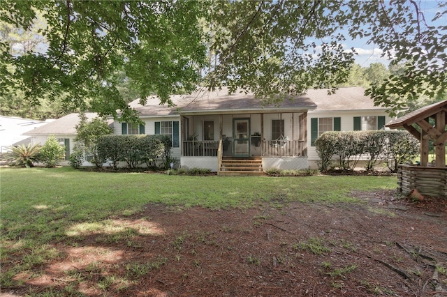 back of property featuring a lawn and a sunroom