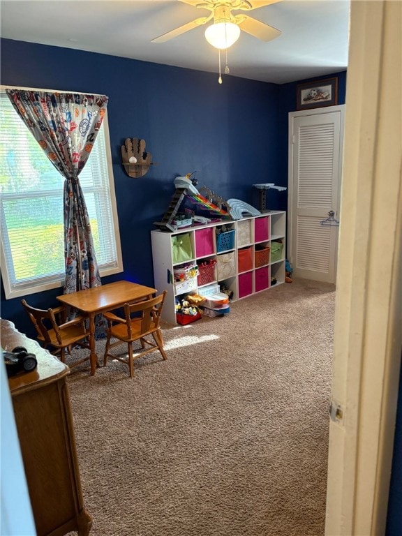 game room featuring a ceiling fan and carpet