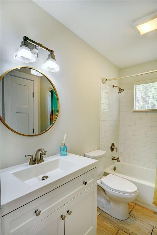 828 Lee St, Brunswick, GA 31520 - full bath featuring vanity, shower / bath combination, and wood finished floors