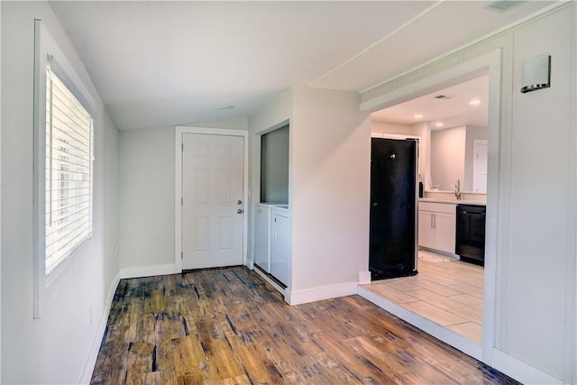 828 Lee St, Brunswick, GA 31520 - entrance foyer featuring independent washer and dryer and wood finished floors