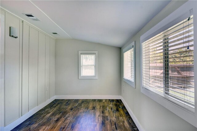 828 Lee St, Brunswick, GA 31520 - spare room featuring lofted ceiling and dark wood-style flooring