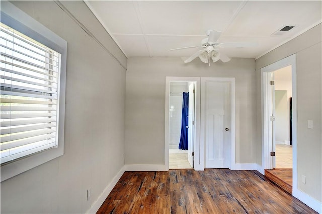 828 Lee St, Brunswick, GA 31520 - unfurnished bedroom featuring hardwood / wood-style floors, ensuite bath, and ceiling fan
