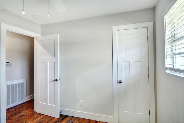 828 Lee St, Brunswick, GA 31520 - unfurnished bedroom with dark wood-type flooring and baseboards